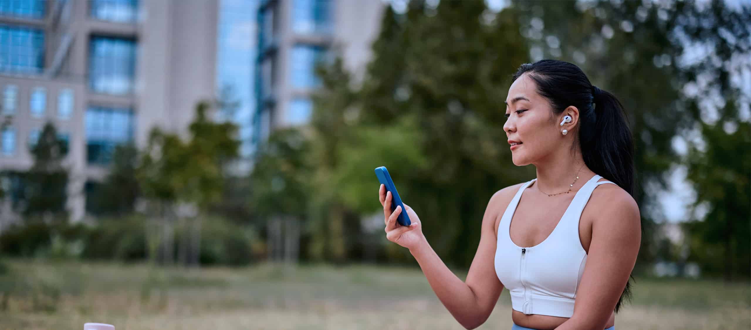 woman-doing-yoga-looking-at-her-phone-benefits